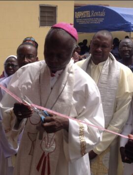 The Catholic Bishop of Ilorin Diocese Most Rev Ayo Maria Atoyebi OP cutting the tape to declare the Skill Acquisition Centre open.